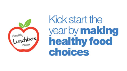 "Kick start the year by making healthy food choices" is written in blue with a white background. To the left of the words is a drawing of an apple with the words "Healthy Lunchbox Week" inside.