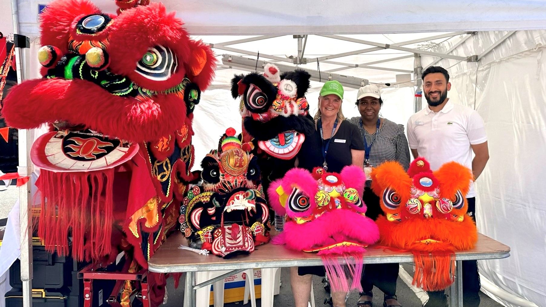 Members of Monash Health’s South East Public Health Unit with lion heads at the Springvale Lunar New Year Festival.