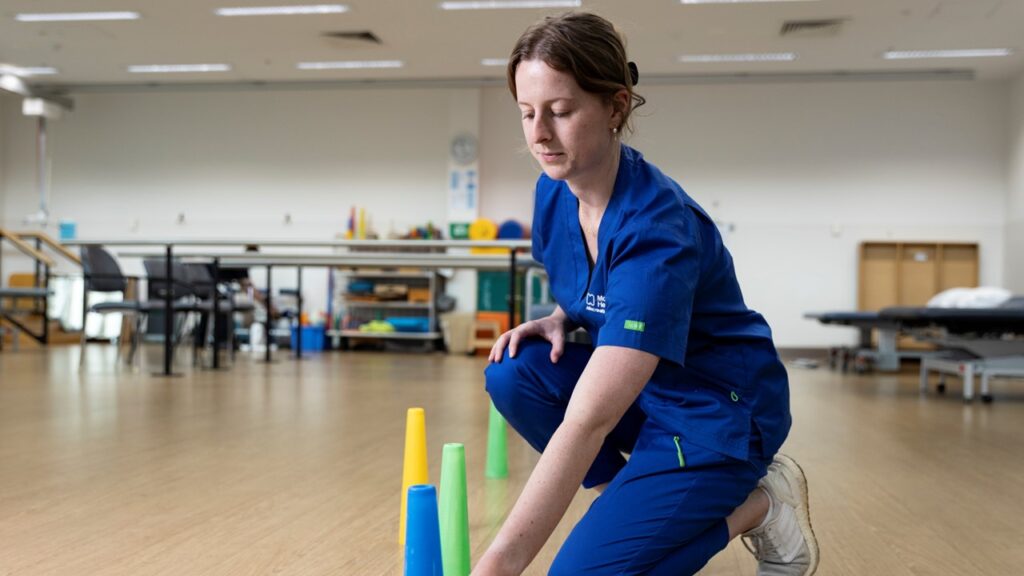 Sophie Clarke 2 1920x1080px Sophie lays out some cones on the gym floor.